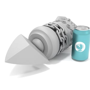 May include: A white, 3D printed rocket-shaped object with a chain and a textured surface. The object is lying on its side, with the tip of the rocket pointing to the left. A blue can with a white logo is standing upright to the right of the object.