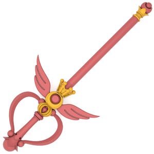 May include: A pink and gold wand with a heart-shaped handle and a crown at the top. The wand has wings on either side of the handle.