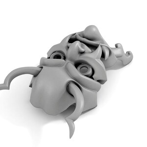 May include: A pair of gray, stylized, ceramic masks with horns and exaggerated features. The masks are stacked on top of each other.
