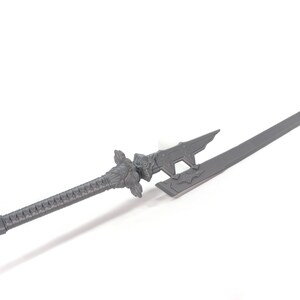 May include: A grey, decorative sword with a detailed handle and a sharp blade. The sword has a unique design with intricate carvings and a pointed tip.