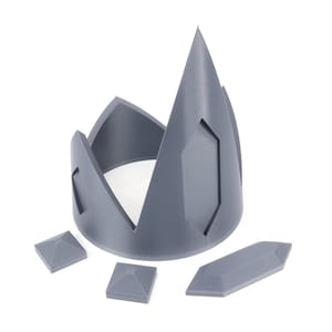 May include: A gray plastic crown with a pointed top and four separate pieces. The crown is designed to be assembled.