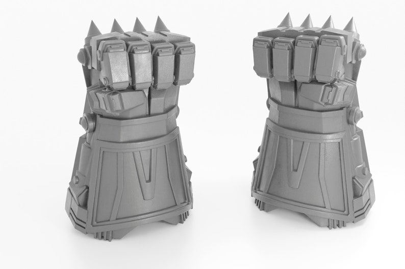 May include: A pair of gray, 3D printed, robotic hands with spiked knuckles. The hands are closed into fists and have a detailed design.