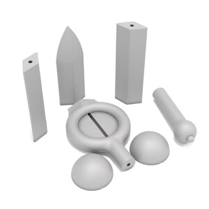 May include: A set of seven gray ceramic pieces, including a ring with a slit, two spheres, a cylinder, and three rectangular prisms.