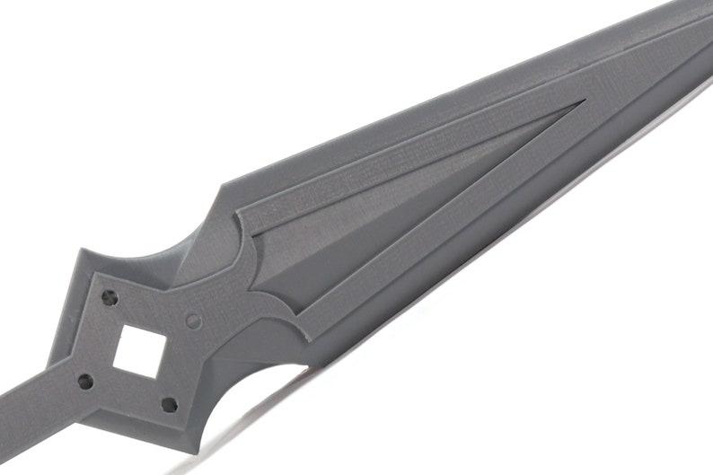 May include: A gray plastic sword with a pointed tip and a decorative design on the handle.