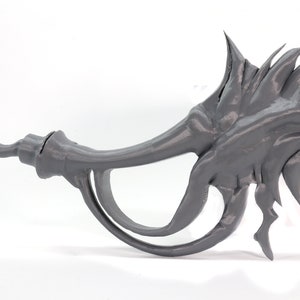 May include: A gray 3D printed dragon claw prop with a sharp, curved point and a textured, spiky surface.