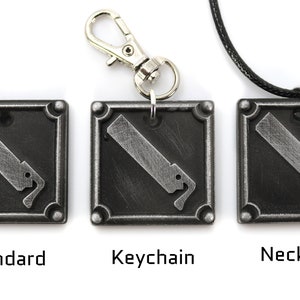 May include: Three metal keychains with a stylized image of a saw blade. The keychains are shown in three different styles: standard, keychain, and necklace.