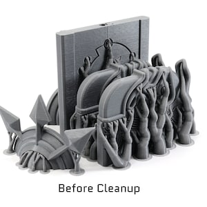 May include: A 3D printed model of a fantasy creature with multiple arms and a large, flat head. The creature is standing on a base with a textured surface. The model is gray and has a rough, unfinished appearance. Before Cleanup.