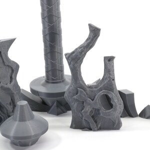May include: Five gray 3D printed pieces of a sword, including the hilt, blade, and pommel.