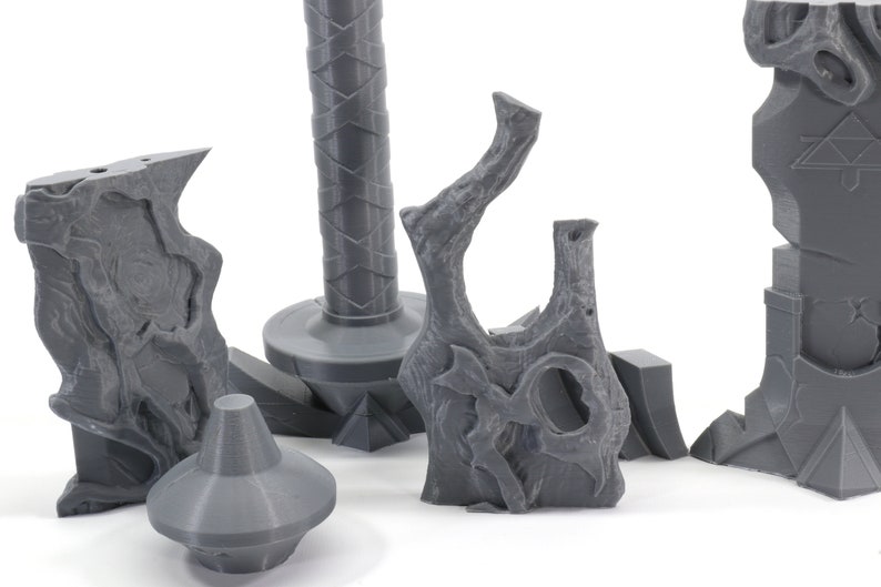 May include: Five gray 3D printed pieces of a sword, including the hilt, blade, and pommel.