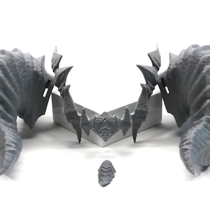 May include: A set of three gray 3D printed horns with a textured surface. The horns are arranged in a symmetrical pattern with the two larger horns on either side and the smaller horn in the center.