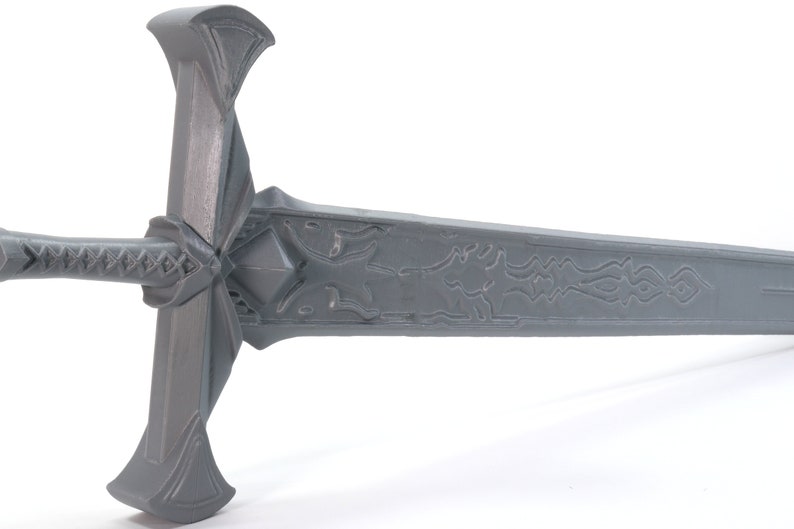 May include: A gray metal sword with a detailed design on the blade and a cross-shaped hilt.