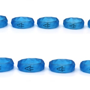 May include: Ten blue silicone rings with a geometric design and a small logo in the center.