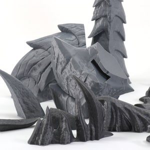 May include: A set of gray 3D printed dragon scales, claws, and tail pieces. The pieces are designed to be assembled into a larger dragon sculpture.