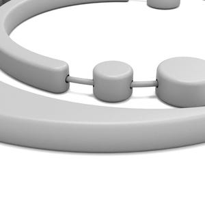 May include: A close-up of a light gray, abstract sculpture with rounded shapes. The sculpture has a curved, semi-circular element and several cylindrical components connected by thin rods. The design is minimalist and modern, set against a white background.