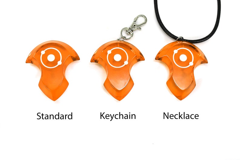 May include: Three orange plastic pendants with a white atom symbol. The pendants are shown in three different styles: standard, keychain, and necklace.