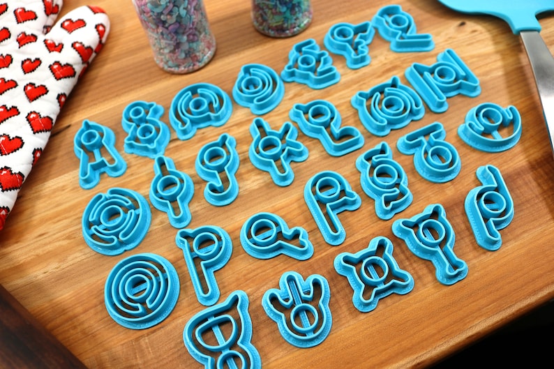 May include: A set of 20 blue plastic cookie cutters shaped like different geometric designs.