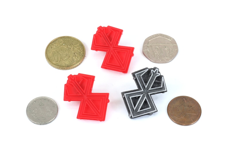 May include: Two 3D printed geometric shapes, one red and one grey, with a complex design. The shapes are similar in size and shape, and are arranged in a symmetrical pattern.