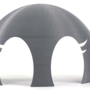 May include: A pair of gray plastic molds with two cut-out shapes. The molds are designed to create a three-dimensional object.