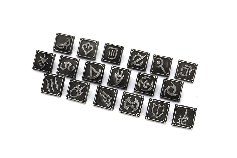 May include: A collection of twenty square, silver-colored metal pins, each featuring a unique symbol. The pins are arranged diagonally on a white surface. The symbols appear to be stylized icons, possibly from a game or fantasy theme.