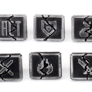 May include: Six black and silver metal tiles with pixelated symbols. The symbols are: ALT, a shield, a bag of coins, two crossed swords, a flame, and a sword.