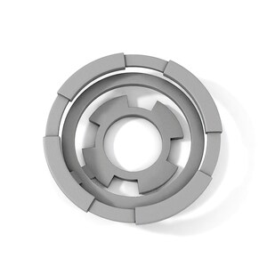 May include: A gray, circular, geometric design with concentric rings and a central starburst shape.