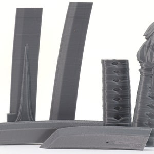 May include: A set of 3D printed gray plastic parts for a sword. The parts include a blade, a handle, and a scabbard.