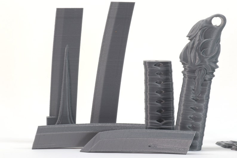 May include: A set of 3D printed gray plastic parts for a sword. The parts include a blade, a handle, and a scabbard.