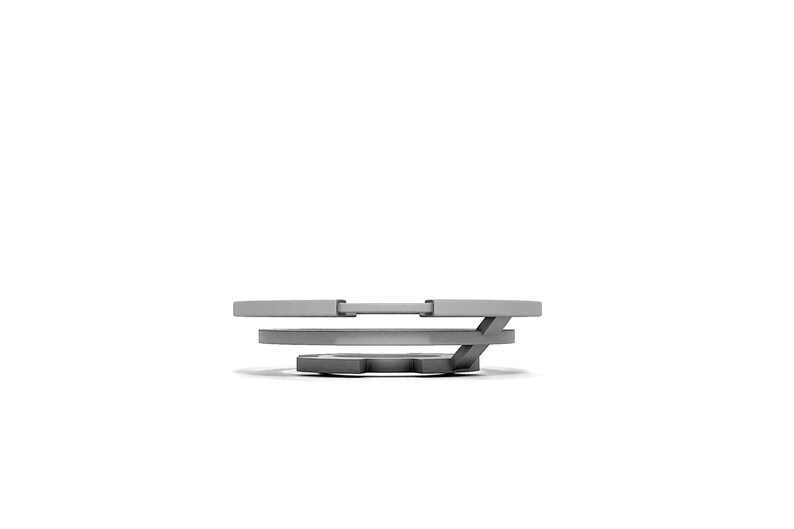 May include: A silver metal ring with three tiers, each tier is a slightly different size and shape. The ring is a decorative object.
