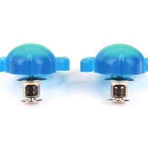 May include: Two blue plastic shoe eyelets with silver metal posts. The eyelets have a rounded top and a flat bottom.