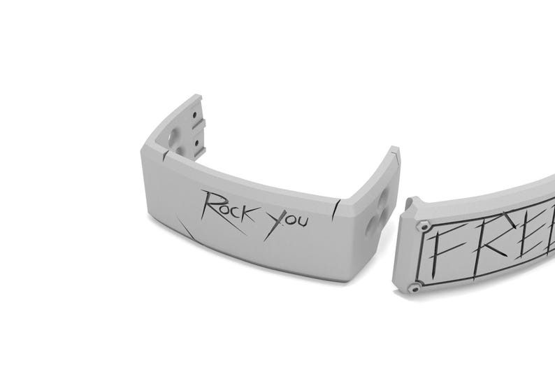 May include: A light gray wristband with the words "Rock You" and "FREE" etched in black. The wristband is segmented, with a curved design and visible screw holes. The background is plain white.