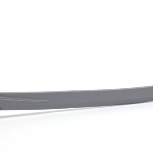 May include: A gray metal sword with a curved blade and a detailed hilt.