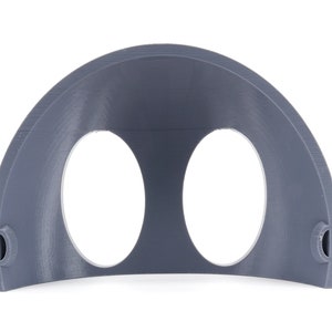 May include: A gray plastic half-dome with two circular openings. The dome is designed to be used as a wall mount for two round objects.