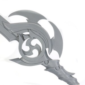 May include: A gray plastic sword with a detailed, intricate design. The sword has a curved blade and a handle with a decorative, swirling pattern.