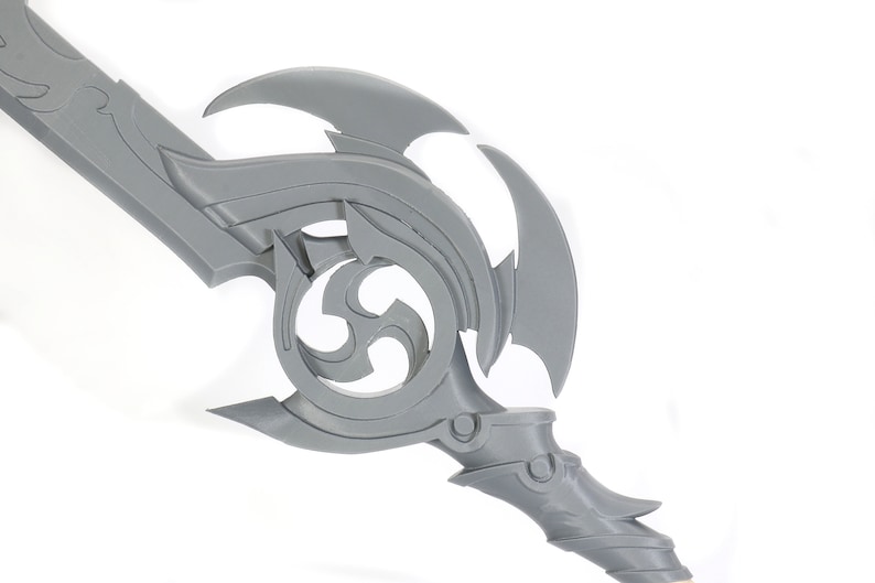 May include: A gray plastic sword with a detailed, intricate design. The sword has a curved blade and a handle with a decorative, swirling pattern.