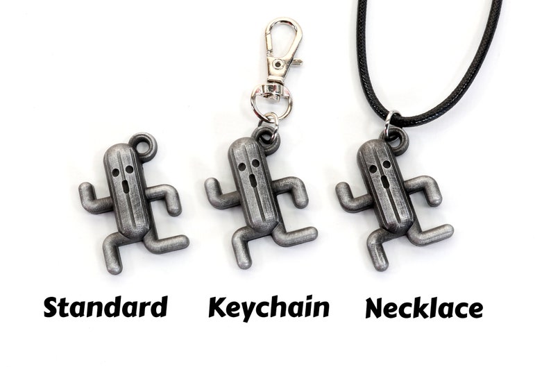 May include: Three silver-colored metal charms in the shape of a running cactus monster. The charms are shown in three different styles: standard, keychain, and necklace.