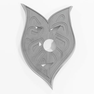 May include: A gray, heart-shaped, decorative wall hanging with a carved design. The design features a circle in the center and intricate patterns around it.