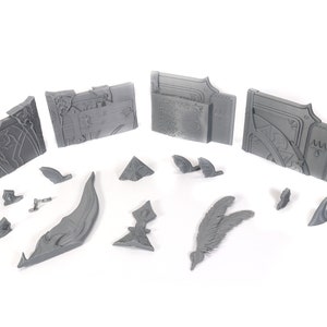 May include: A set of 3D printed gray plastic pieces for a model kit. The pieces include a spear, a wing, a curved piece, and several rectangular pieces with intricate designs.