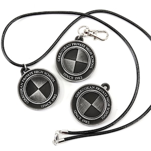 May include: Two black and silver metal pendants with the text "Gekkoukan Private High School Since 1982" on each. The pendants are attached to a black cord.