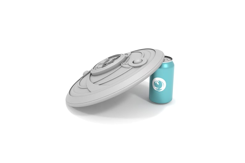 May include: A light gray, decorative lid with a detailed design rests against a teal can. The can features a white logo. The objects are set against a white background.