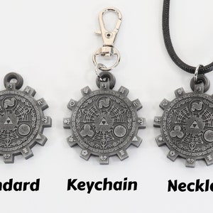 May include: Three versions of a silver-colored pendant featuring a detailed design of a Triforce symbol surrounded by a circular pattern. The pendant is available as a standard piece, a keychain, and a necklace.