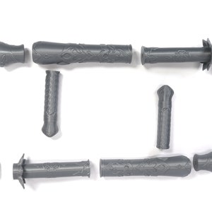 May include: A set of eight gray plastic pieces that can be assembled into a decorative sword. The pieces are detailed with intricate patterns.