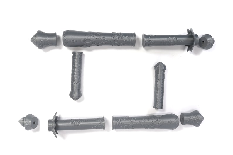 May include: A set of eight gray plastic pieces that can be assembled into a decorative sword. The pieces are detailed with intricate patterns.