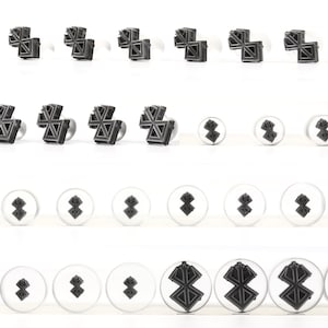 May include: Set of 24 metal cookie cutters in various sizes featuring a geometric star design. The cutters are arranged in four rows of six, with the largest cutters at the top and the smallest at the bottom.