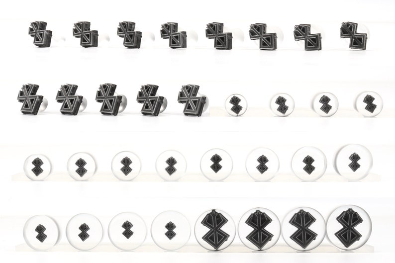 May include: Set of 24 metal cookie cutters in various sizes featuring a geometric star design. The cutters are arranged in four rows of six, with the largest cutters at the top and the smallest at the bottom.
