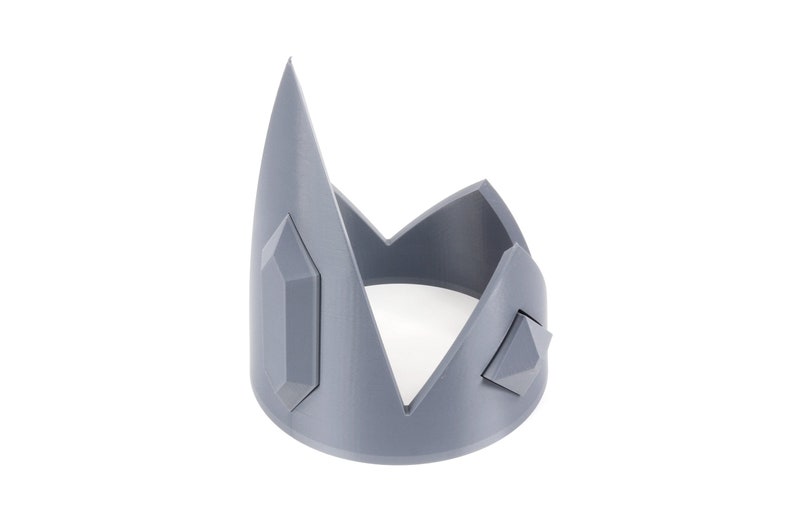 May include: A gray plastic crown with a pointed top and three diamond-shaped embellishments.