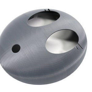 May include: A gray plastic dome with three circular openings. The dome is smooth and has a slightly textured surface.