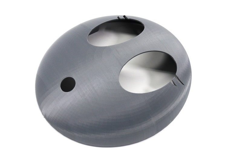 May include: A gray plastic dome with three circular openings. The dome is smooth and has a slightly textured surface.