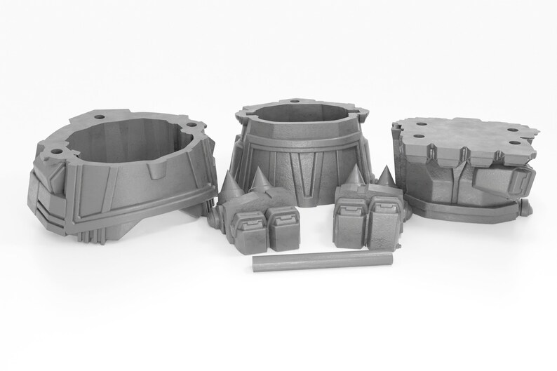 May include: A set of five gray plastic pieces for building a model. The pieces include a base, two legs, and two arms.