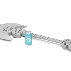 Puede incluir: Una guitarra el&eacute;ctrica plateada en forma de hacha con una lata de refresco azul a su lado.