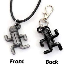 May include: A silver and black charm necklace featuring a running character from the video game Final Fantasy. The charm is shown from the front and back.